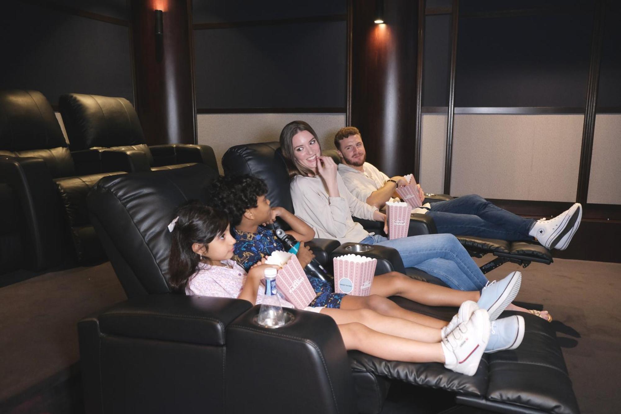Отель Charthouse Bahrain Манама Экстерьер фото A family watching a movie in a home theater